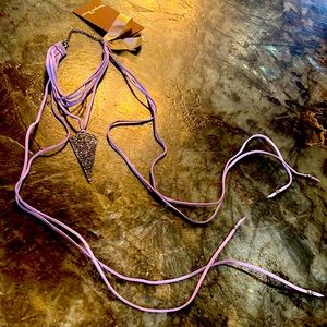 Pendent with lavender leather with center piece with small dark crystals